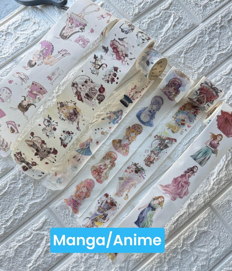 May include: A selection of washi tape rolls with manga and anime-style illustrations. The tape designs showcase anime characters in diverse outfits, floral patterns, and other decorative elements. The text "Manga/Anime" is displayed in a blue rectangle.