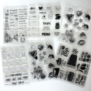 May include: Clear stamps featuring kitchen utensils, food illustrations, and phrases like "Treat Yourself" and "Menu." Includes images of strawberries, desserts, and cooking tools. Ideal for crafting and scrapbooking.