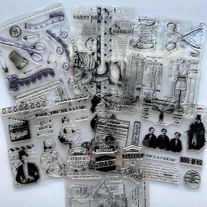 May include: A collection of clear photopolymer stamps featuring various designs including a carousel horse, sewing tools, a dress form, vintage film elements, and text such as HAPPY DAYS, FATHER'S DAY, and DARE DEVIL on transparent sheets.
