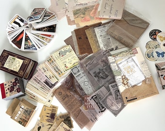 May include: A collection of vintage-style paper ephemera, including postcards, envelopes, and decorative stickers. The assortment features various sizes and designs, with a focus on aged paper textures and antique illustrations. A deck of cards is also included.