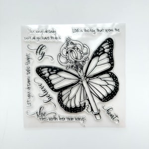 May include: Clear stamp set with a butterfly and key design. The text reads "Your wings already exist all you have to do is fly", "Let your dreams take flight, believe", "LOVE is the key that opens the heart", and "She flies with her own wings".