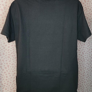 May include: Black short-sleeved t-shirt.