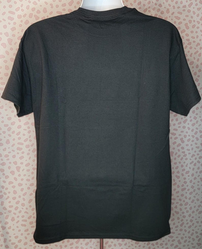 May include: Black short-sleeved t-shirt.