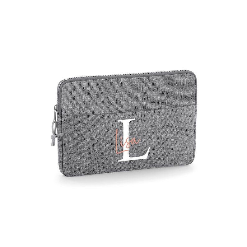 May include: Gray laptop sleeve with a white letter L and the name Lisa in a pink script font.