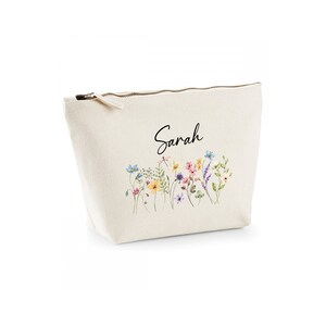 May include: A beige canvas zippered pouch with a floral print and the name "Sarah" printed in black.