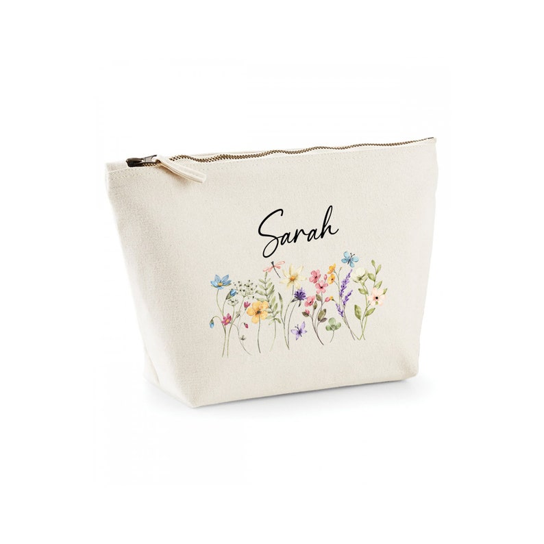 May include: A beige canvas zippered pouch with a floral print and the name "Sarah" printed in black.