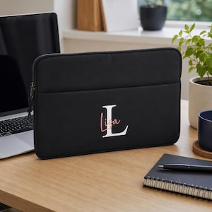 Personalised black 13-inch laptop bag with custom name and case, styled lifestyle photograph — ideal university, college or graduation gift.