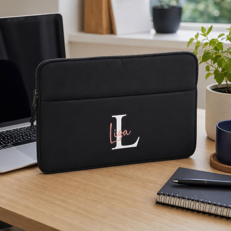 Personalised black 13-inch laptop bag with custom name and case, styled lifestyle photograph — ideal university, college or graduation gift.