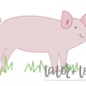 May include: Embroidered design of a pink pig standing on green grass with the text "tater+tots designs" below.