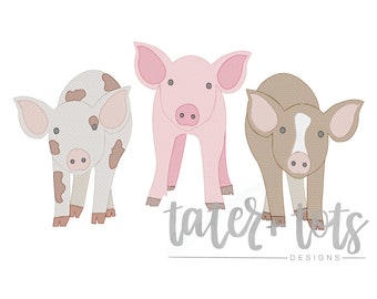 May include: Three embroidered pig designs in a row. The pigs are in shades of white with brown spots, pink, and brown with a white face. The text "tater + tots DESIGNS" is below the pigs.