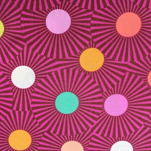 May include: A pink fabric with a repeating pattern of colorful circles with radiating lines. The circles are in shades of pink, orange, yellow, green, and white.