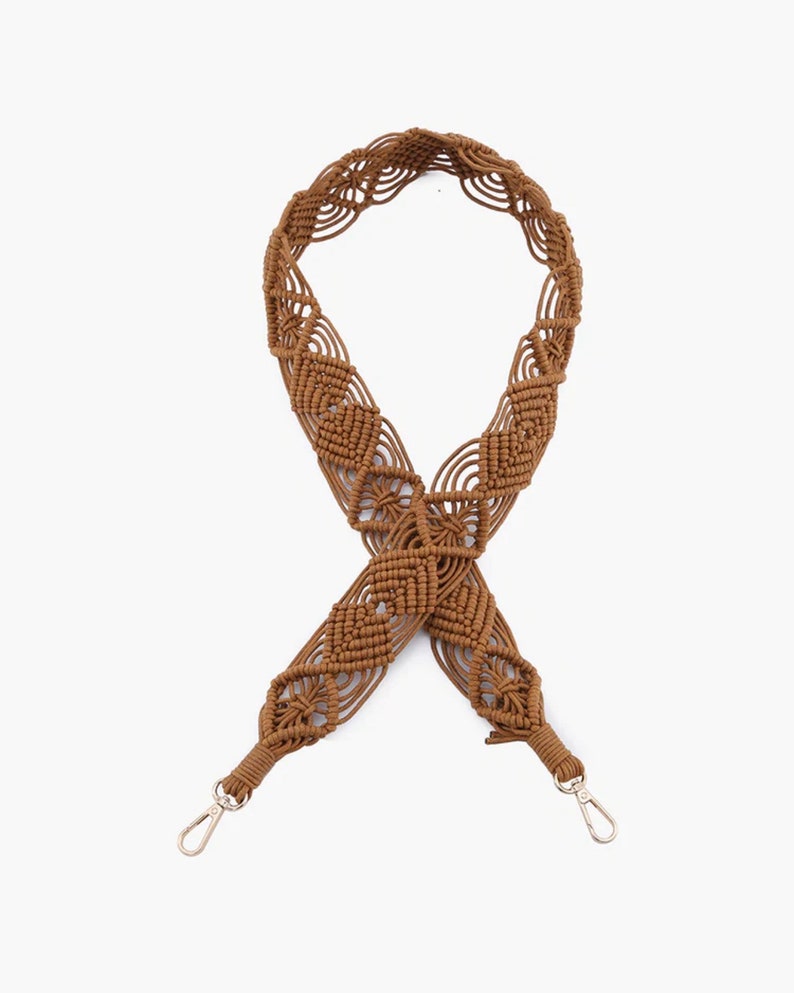 May include: A brown crocheted bag strap with a diamond pattern and silver clasps.