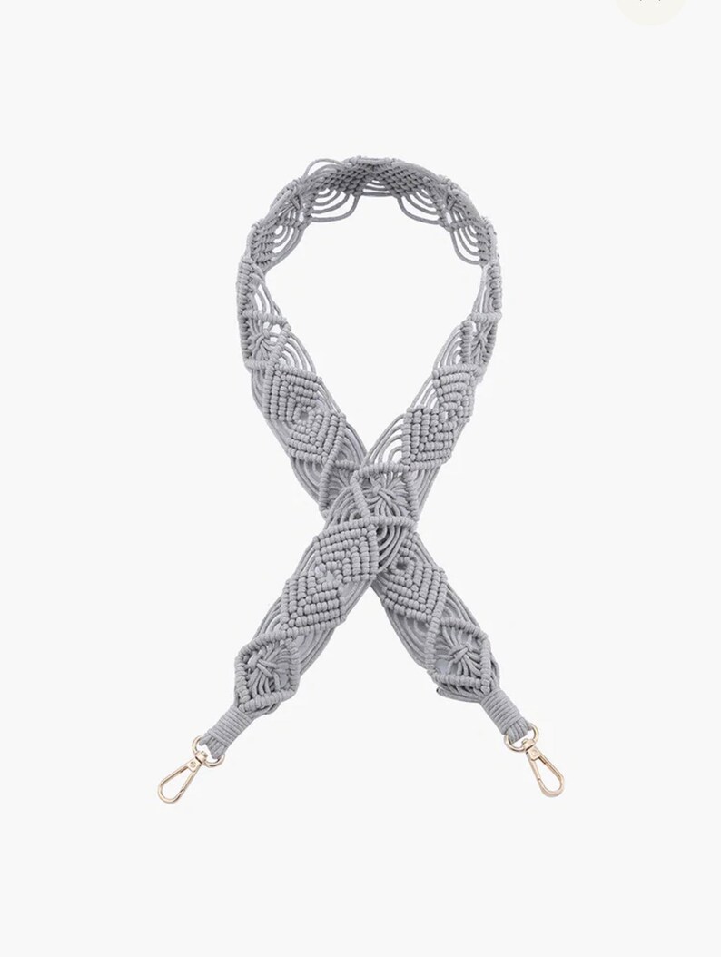 May include: A gray macrame strap with gold metal clasps. The strap is made of a thick, woven cord and has a diamond pattern.