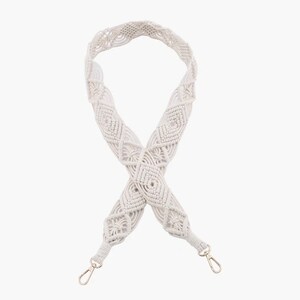 May include: White macrame bag strap with silver clasps. The strap is made of a thick, woven cord and has a diamond pattern.
