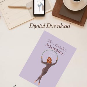 Puede incluir: Imagen de una descarga digital con un diario titulado "The Aerialist's JOURNAL" con una ilustración de una mujer en un aro. Un smartphone muestra una imagen similar. También son visibles las palabras "Digital Download".
