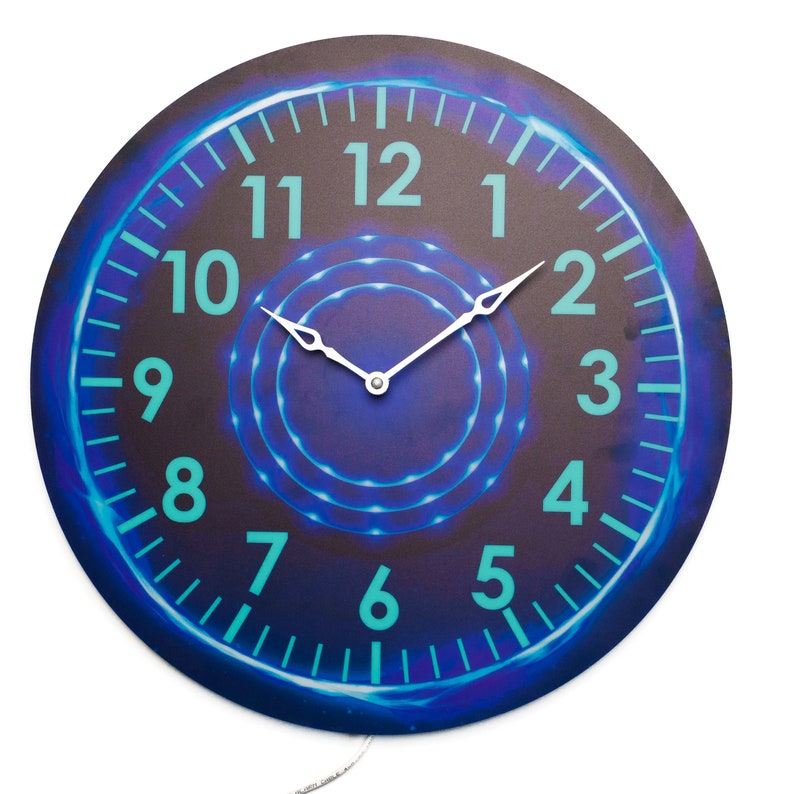 May include: A round clock with a blue and purple background. The clock face has a white ring with blue neon lights around it. The numbers are in a turquoise color. The clock hands are white.