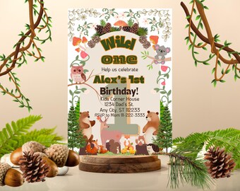 May include: A woodland-themed first birthday party invitation with a brown number one, the words "Wild One", and the name "Alex". The invitation features a variety of woodland animals, including owls, bears, and a koala.
