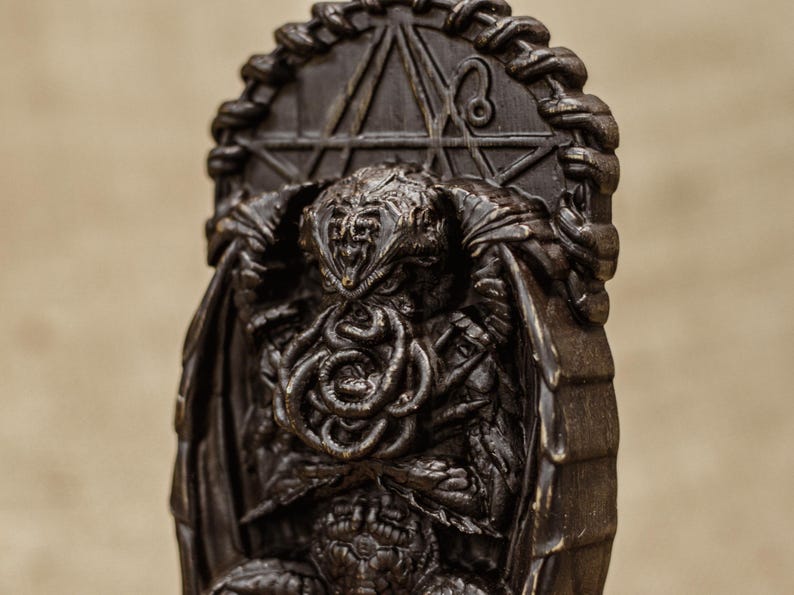 May include: A dark brown, detailed, sculpted figurine of Cthulhu, the fictional cosmic entity, sitting on a throne with a pentagram behind him.