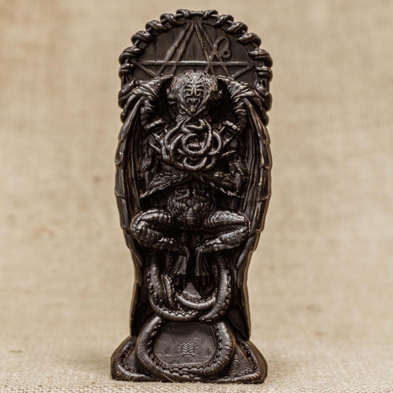 May include: A dark brown, detailed, sculpted figurine of Cthulhu, a fictional cosmic entity, with tentacles and wings. The figurine is standing on a base with a circular design.