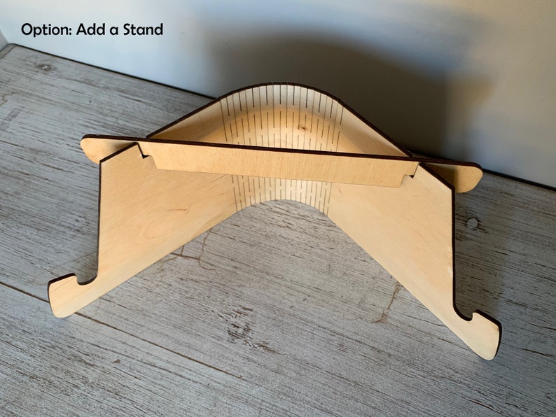 May include: A wooden laptop stand with a natural finish. The stand is folded up and ready to be used. Option: Add a Stand.