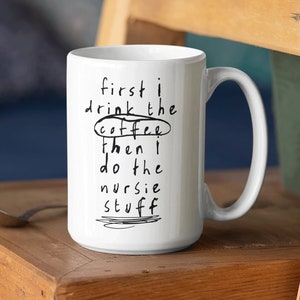 May include: White ceramic mug with black text that reads "first i drink the coffee then i do the nursie stuff".