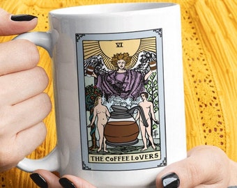 May include: White ceramic mug with a tarot card design featuring a coffee pot and the text "The Coffee Lovers".