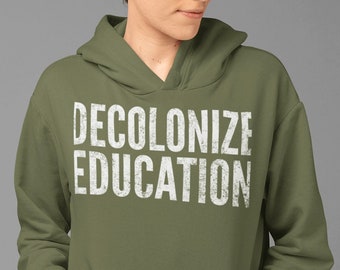 May include: A green hooded sweatshirt with the text "DECOLONIZE EDUCATION" printed in white on the front.