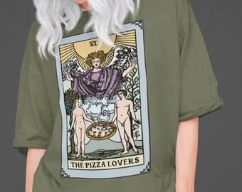May include: A green t-shirt with a graphic of a tarot card depicting a pizza. The card is titled "The Pizza Lovers" and features a couple holding a pizza with an angel above them.