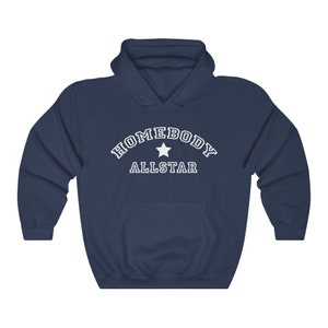 May include: Navy blue hooded sweatshirt with white text that reads "Homebody Allstar" with a white star in the middle of the text.