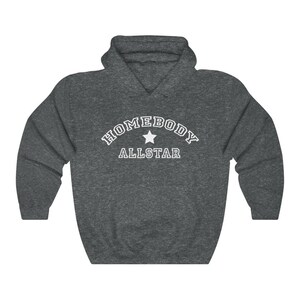 May include: A dark gray hooded sweatshirt with the text "HOMEBODY ALLSTAR" in white with a white star in between the words.