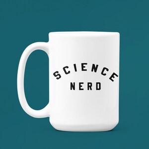 May include: White ceramic mug with a black inscription that reads "SCIENCE NERD" in an arched design.