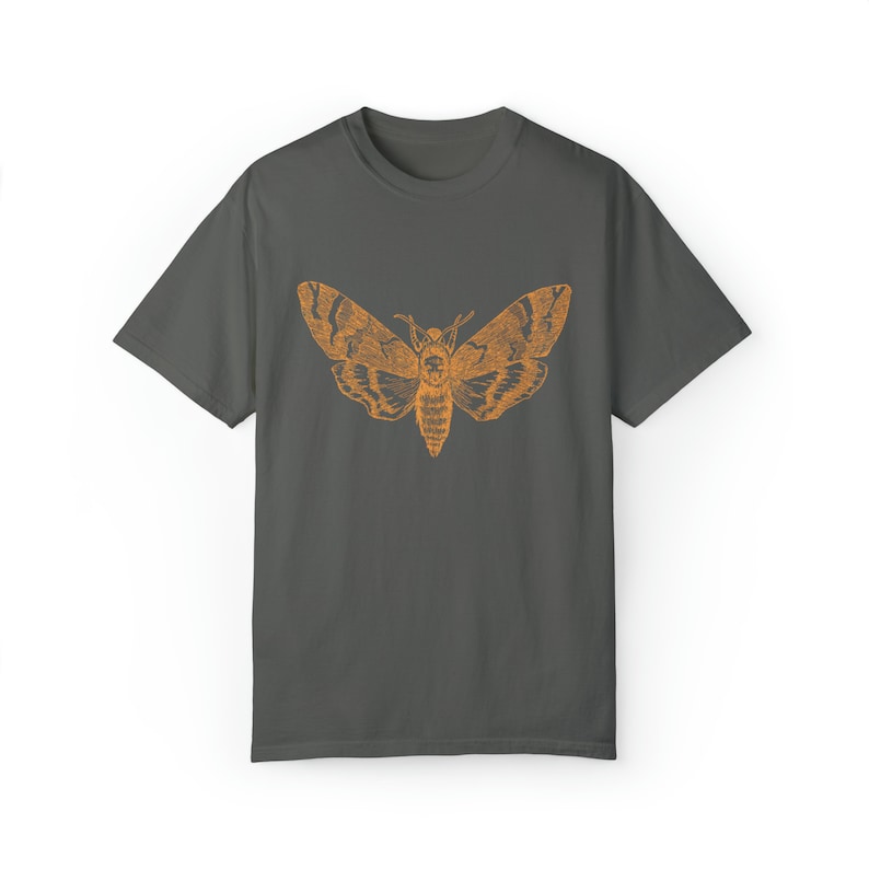 May include: A dark gray t-shirt with an orange silhouette of a moth printed on the front.