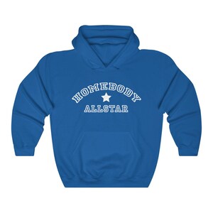 May include: A royal blue hooded sweatshirt with the text "HOMEBODY ALLSTAR" in white with a white star in between the words.