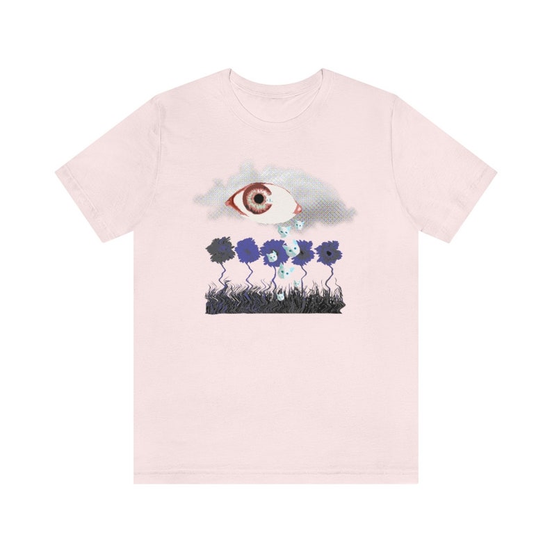 May include: Pink t-shirt with a graphic of a large eye in a cloud crying small white eyes onto a field of blue flowers.