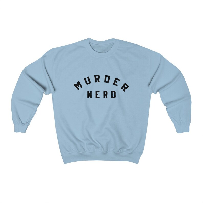 May include: A light blue sweatshirt with the text "MURDER NERD" printed in black.