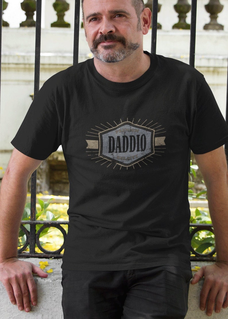 May include: A black t-shirt with a vintage-style graphic that says "World's Greatest Dad, Dad, Daddy, Old Man, Pops, Papa".