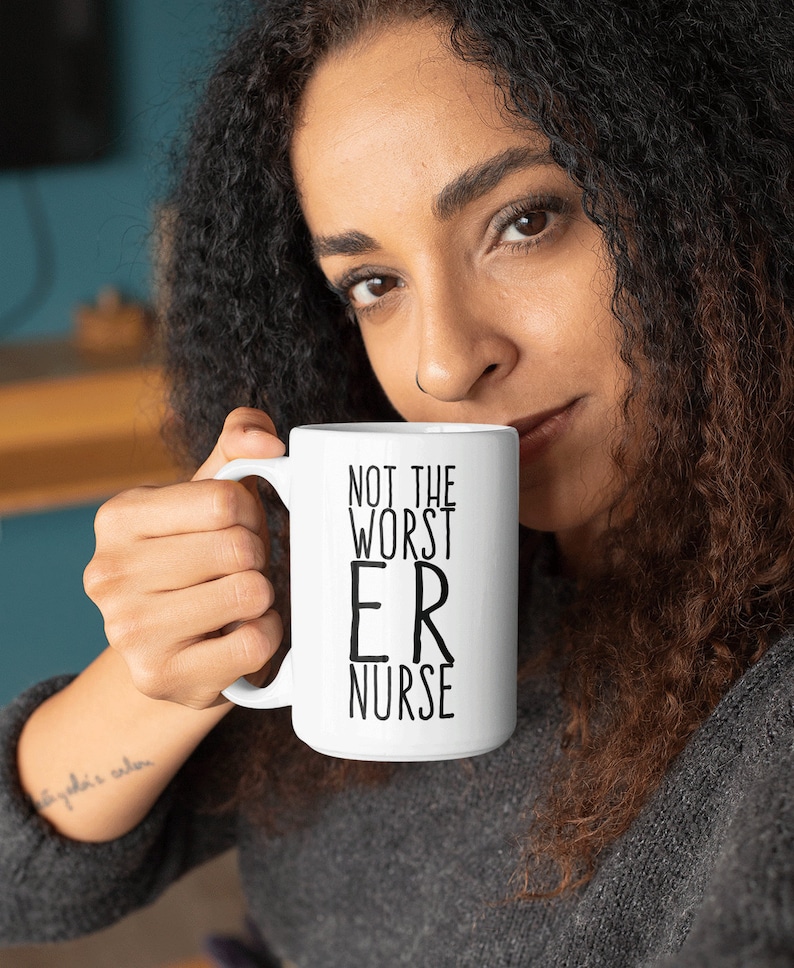 May include: White ceramic mug with black text that reads "Not the worst ER nurse".