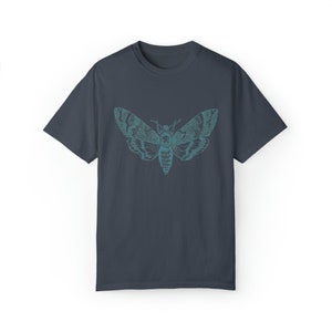 May include: A dark blue t-shirt with a teal and blue graphic of a moth with wings spread.