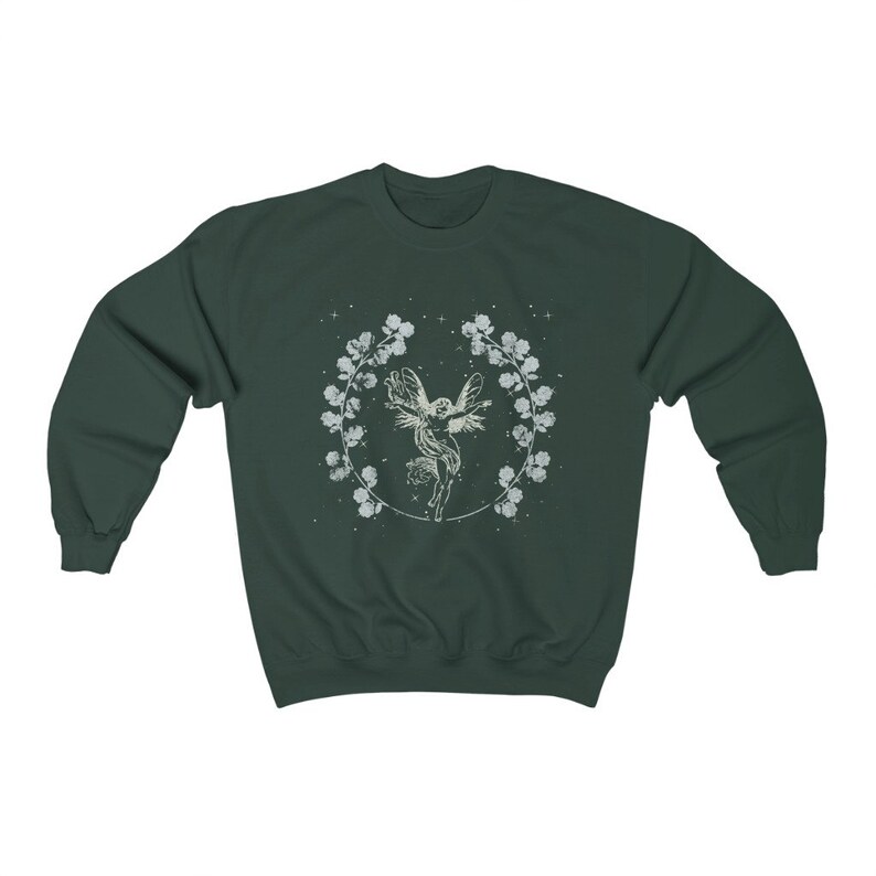 May include: A dark green sweatshirt with a white graphic of a fairy flying inside a circle of flowers.