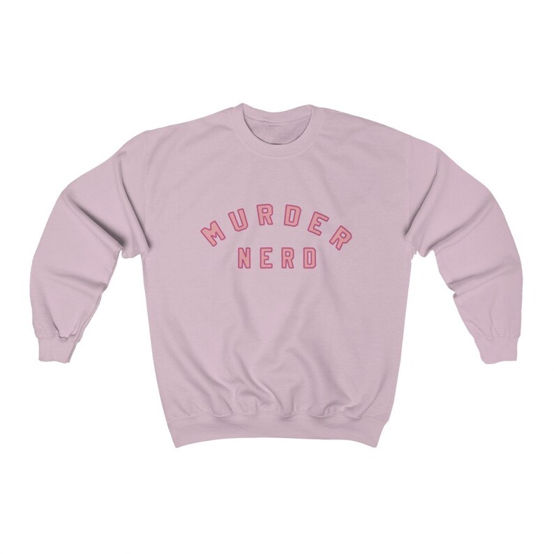 May include: A light pink sweatshirt with the text "MURDER NERD" in pink with a red outline.