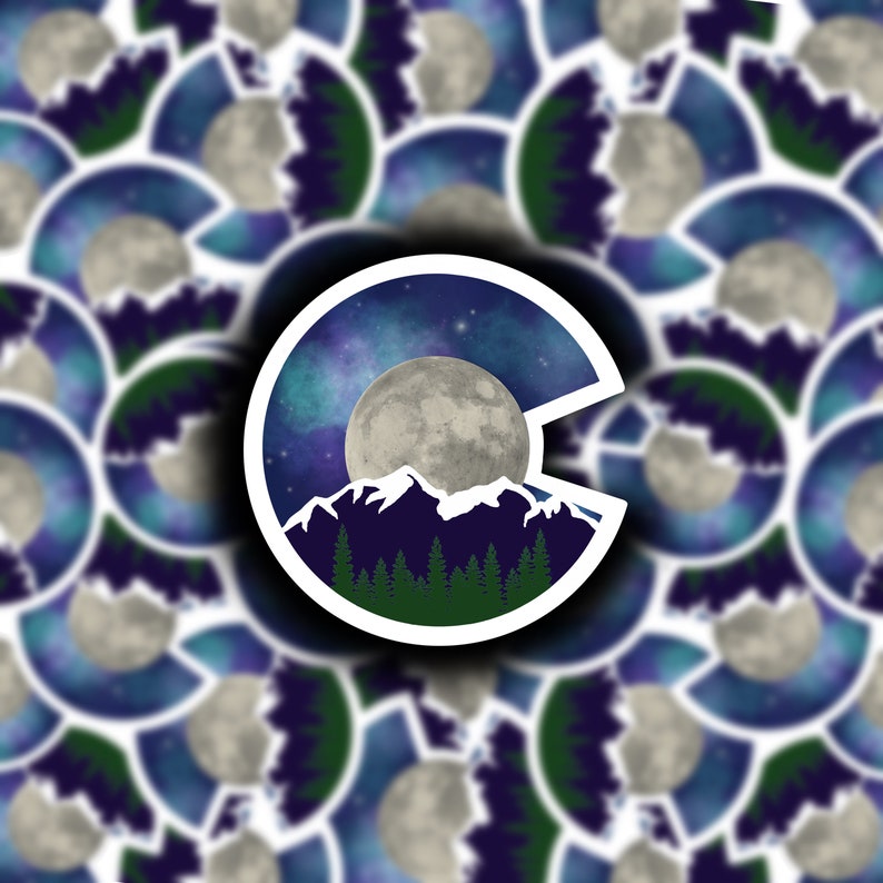 May include: A sticker featuring a stylized outline of the state of Colorado with a full moon, mountains, and a starry night sky.