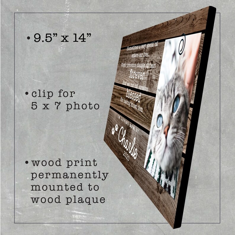 May include: A wood plaque with a clip for a 5x7 photo. The plaque is 9.5 inches by 14 inches and features a wood grain design. The plaque has a quote about the love of pets and a paw print with the name "Charlie" and the year "2020". A photo of a cat with blue eyes is in the clip.