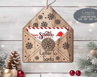 May include: A wooden envelope with a snowflake pattern and the text "Dear Santa" and "Letter To Santa". The envelope is open and a white card with red stripes is inside. The card has the text "Dear Santa" on it.