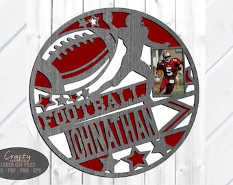 May include: A circular wooden cutout with a football theme. The design includes a football, a player, stars, and the name "Jonathan" in a bold font. A small photo of a football player is included.