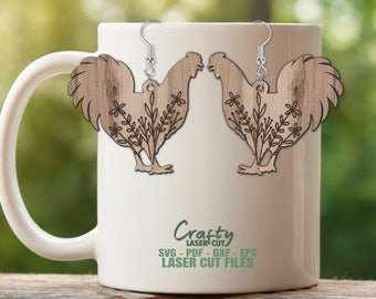 May include: Wooden rooster earrings with floral accents. The earrings are light brown with a wood grain texture and silver-colored hooks. The rooster design is laser cut with floral details. The earrings are displayed on a white mug.