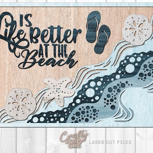 May include: Laser cut file design for a wooden sign with the text "Life is better at the beach" in black lettering. The design also includes a starfish, seashells, and waves.