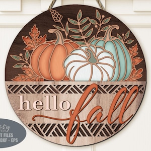 A Hello Fall Pumpkin Door Sign SVG Laser Cut File with a trio of pumpkins and fall leaves in a basket for use with your Glowforge, XTool and other laser machines.