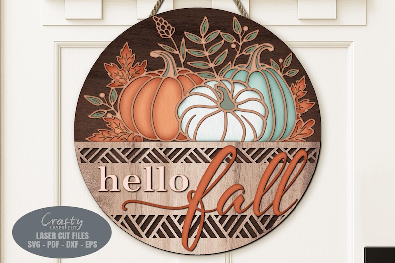 A Hello Fall Pumpkin Door Sign SVG Laser Cut File with a trio of pumpkins and fall leaves in a basket for use with your Glowforge, XTool and other laser machines.
