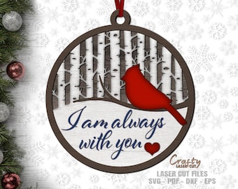 May include: A wooden Christmas ornament featuring a red cardinal perched on a snowy branch in a birch tree forest. The ornament has the text "I am always with you" and a small red heart.