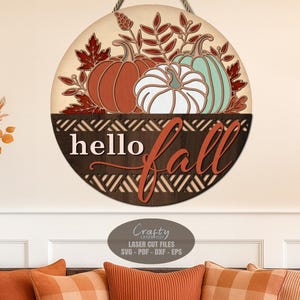 A Hello Fall Door Sign SVG Laser Cut File with a Pumpkin Welcome Sign SVG theme including fall leaves in a basket for use with your Glowforge, XTool and other laser machines.